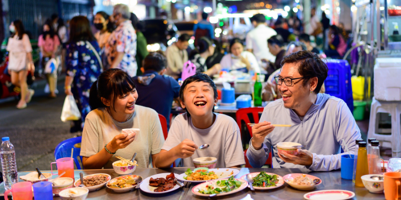 Family of three eating street food In Thaialand
